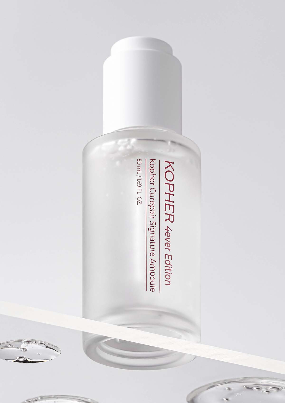 Kopher skincare ampoule bottle on a light gray background